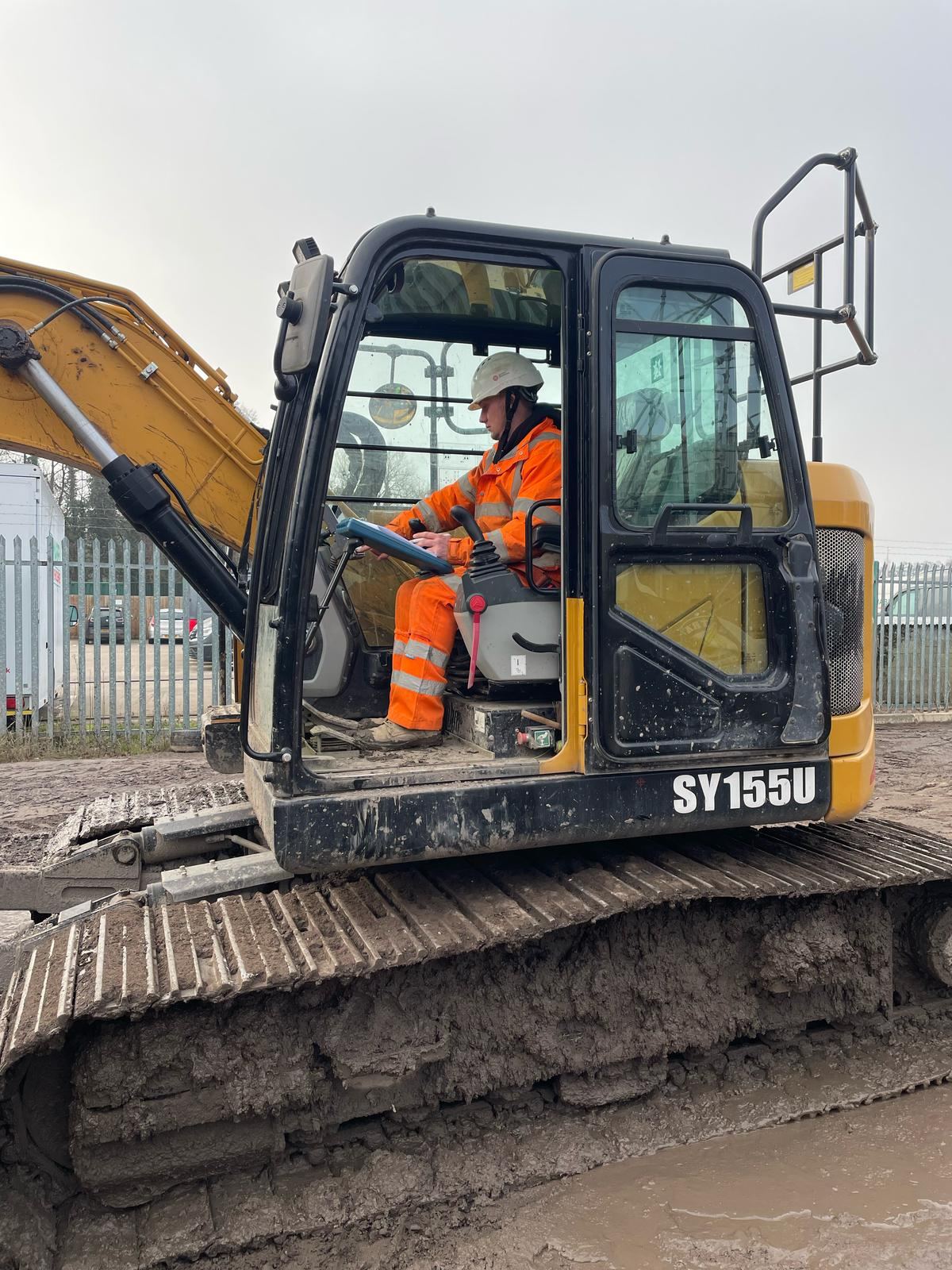 NPORS operator in the cab of an excavator